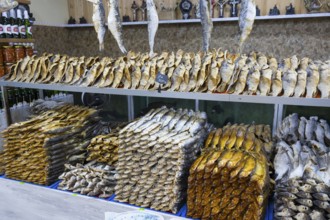 Fish piled up in different heights and patterns on a market shelf, fish sale, Tsovagyugh, Lake