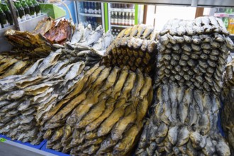 Stacks of fish in different patterns and heights on a market display shelf, fish sale, Tsovagyugh,