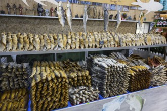 Different types of fish are displayed on a decorated shelf in a market, fish sale, Tsovagyugh, Lake