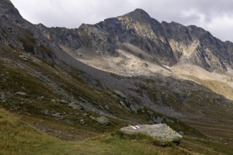 Hiking trail marker at Passo del Sole with Bassa di Pos Lei, Quinto, Ticino, Switzerland