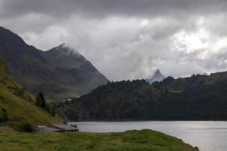 On the shore of Lago Ritom, view towards Passo Sole, Airolo, Ticino, Switzerland