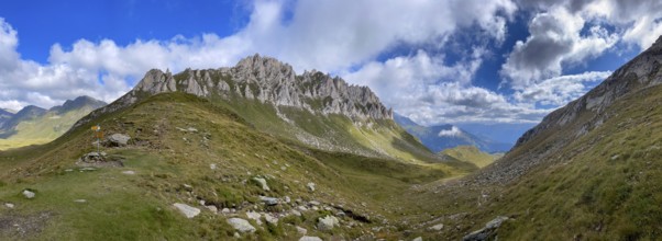 View from Passo del Sole towards Blenio Valley and Lukmanier, on the left steep rock faces at