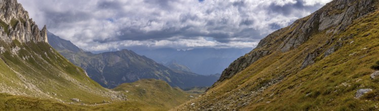 View from Passo del Sole towards Blenio Valley and Lukmanier, on the left steep rock faces at