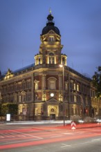 Old head post office with light strips of moving cars at the blue hour, Hamburg, Germany