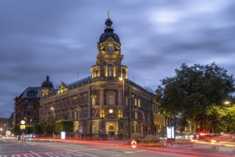 Old head post office with light strips of moving cars at the blue hour, Hamburg, Germany