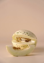 Hybrid honeydew melon on a beige background