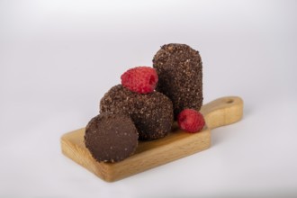 Cocoa and raspberry cake on a board, copy space