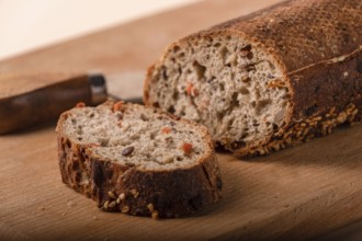 Slices of whole grain bread with carrots and seeds, close-up