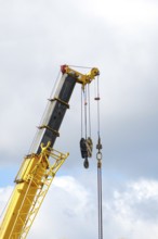 Yellow crane boom against sky background, copy space