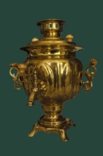 A 19th-century brass samovar, isolated on a green background, Russia
