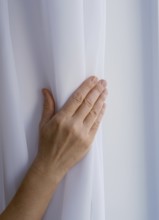 Female hand on nylon fabric