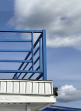 Blue railings on white pier, space for text
