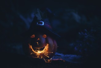 Glowing pumpkin with sparks in the dark, Halloween