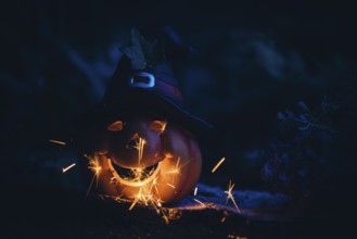 Glowing pumpkin with hat and sparks in a dark, mystical atmosphere, Halloween