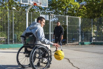 Two men experiencing disabilities, one in a wheelchair and another with a prosthetic leg, are
