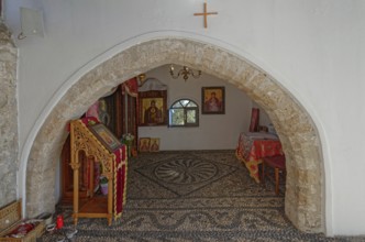Interior of a church of the Virgin Mary Tsambika (Kyra Psili), with stone arch and icons, spacious