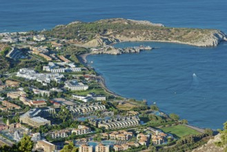 Coastal landscape of Kolymbia with bay and mountainous surroundings on a clear day, Church of the