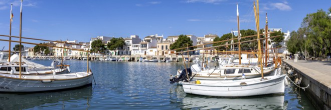 Portocolom fishing village on Majorca panorama with boats and colourful houses holiday by the sea