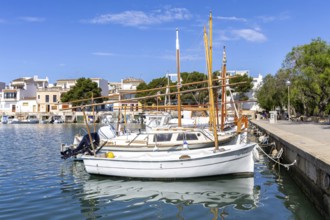 Portocolom fishing village on Majorca with boats and colourful houses Holiday by the sea in