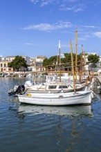 Portocolom fishing village on Majorca with boats and colourful houses Holiday by the sea in