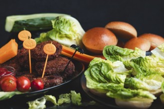 Burgers with Halloween decorations and colourful ingredients such as lettuce and tomatoes