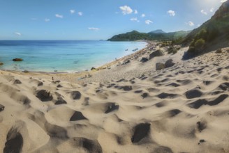 Sand dunes lead to the picturesque Tsambika beach with clear blue water and mountains in the