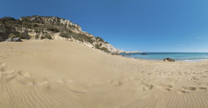 Extensive Tsambika sandy beach with rocks and calm turquoise sea under a clear blue sky, Tsambika