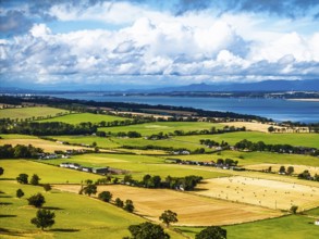 Fields and farms over Scotish farms and Forth Estuary from drone, House of the Binns, Binns Tower,
