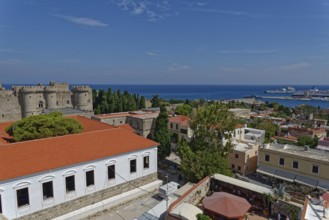 View of a historic town with castle, red roofs and sea in the background, Medieval Town of Rhodes,