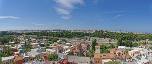 Historic old town with colourful houses and green trees under a clear blue sky, Roloi Clock Tower,