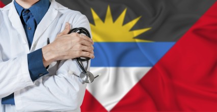 Doctor with stethoscope on Antigua and Barbuda flag. Doctor holding stethoscope on Antiguan and