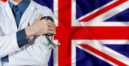 Doctor with stethoscope on United Kingdom flag. Doctor holding stethoscope on British flag