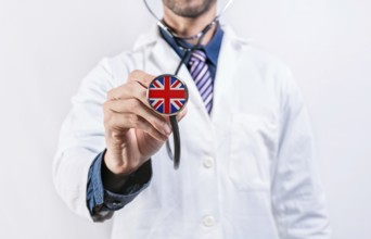 United Kingdom healthcare system, doctor holding stethoscope. United Kingdom health and medical