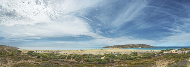 Panoramic view of the wide beach of Prasonisi with blue sea and dramatic sky full of clouds,