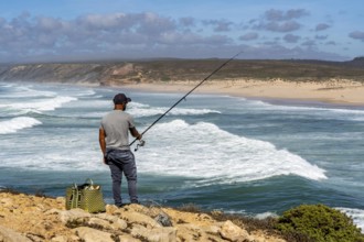 Anglers on the cliffs at the viewpoint above Praia da Bordeira beach, near Carrapateira, popular