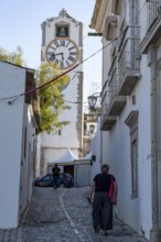 Old town alleys, catholic church Igreja de Santa Maria do Castelo in Tavira, in the Algarve,