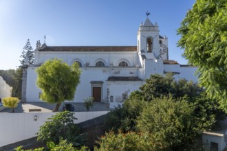 Old town alleys, catholic church Igreja de Santa Maria do Castelo in Tavira, in the Algarve,