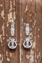 The old town centre of Tavira, typical door knockers found on many wooden doors in the town,