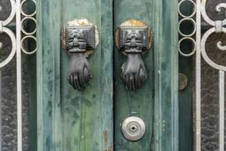 The old town centre of Tavira, typical door knockers found on many wooden doors in the town,