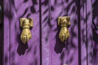 The old town centre of Tavira, typical door knockers found on many wooden doors in the town,