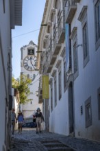 Old town alleys, catholic church Igreja de Santa Maria do Castelo in Tavira, in the Algarve,