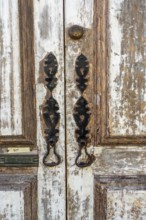 The old town centre of Tavira, typical door knockers found on many wooden doors in the town,