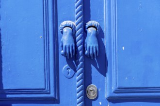 The old town centre of Tavira, typical door knockers found on many wooden doors in the town,