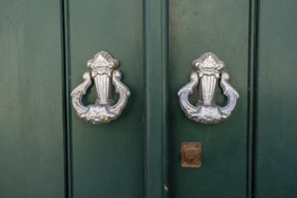 The old town centre of Tavira, typical door knockers found on many wooden doors in the town,