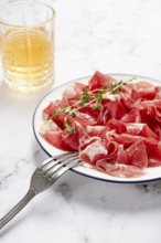 Plate with sliced cured meat, pork neck, prosciutto coppa, Italian delicacy