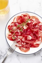 Plate with sliced cured meat, pork neck, prosciutto coppa, Italian delicacy