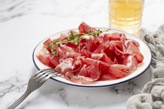Plate with sliced cured meat, pork neck, prosciutto coppa, Italian delicacy
