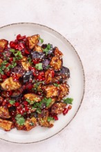 Fried eggplant, Chinese style, in sweet and sour sauce, with pepper and sesame seeds. on a white