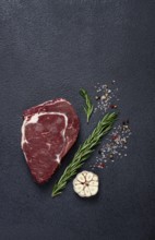 Raw steak, beef steak, rib eye steak, on the table, top view, no people, on a dark background