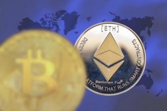 (Photomontage) Cryptocurrencies: Symbolic Bitcoin and Ethereum, cropped in front of a world map